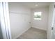Functional laundry room with wood-look tile floor, utility connections, and wire shelving at 9529 Calumet Blvd, Port Charlotte, FL 33981