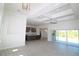 Expansive living area connected to the kitchen, featuring recessed lighting, ceiling fan, and glass doors to the patio at 9529 Calumet Blvd, Port Charlotte, FL 33981