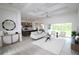 Open-concept living room with coffered ceilings, wood-look tile flooring, and sliding glass doors to enjoy the view at 9529 Calumet Blvd, Port Charlotte, FL 33981