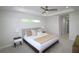 Bright main bedroom with tray ceiling, ceiling fan, carpet, a king bed, and modern decor at 9529 Calumet Blvd, Port Charlotte, FL 33981