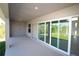 A covered patio features sliding glass doors that open to a lush backyard and ample natural light at 9529 Calumet Blvd, Port Charlotte, FL 33981