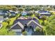 Aerial view showcasing the home, a screened-in pool, and an expansive, well-maintained lawn at 1068 Harbour Cape Pl, Punta Gorda, FL 33983
