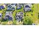 An aerial view showcases the neighborhood homes with manicured lawns and screened in pools at 1068 Harbour Cape Pl, Punta Gorda, FL 33983