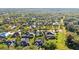 An aerial shot displays the neighborhood homes nestled among trees with water in the distance at 1068 Harbour Cape Pl, Punta Gorda, FL 33983