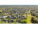 An aerial shot displays the neighborhood homes nestled among trees with water in the distance at 1068 Harbour Cape Pl, Punta Gorda, FL 33983