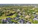 An aerial view of homes featuring lush greenery and multiple properties equipped with solar panels at 1068 Harbour Cape Pl, Punta Gorda, FL 33983