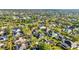 An aerial perspective of a community dotted with homes, swimming pools, and mature tree coverage at 1068 Harbour Cape Pl, Punta Gorda, FL 33983
