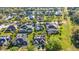 An aerial view captures the lush neighborhood with well-maintained lawns, trees, and beautiful homes at 1068 Harbour Cape Pl, Punta Gorda, FL 33983