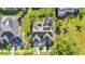 An aerial view showing the home's backyard pool, solar panels, landscaping, and proximity to neighbors at 1068 Harbour Cape Pl, Punta Gorda, FL 33983