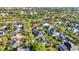 Aerial picture of a residential neighborhood filled with leafy trees, manicured landscapes, and diverse home designs at 1068 Harbour Cape Pl, Punta Gorda, FL 33983