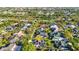 Beautiful aerial view of neighborhood highlighting the home's landscaping, pool, and solar panels at 1068 Harbour Cape Pl, Punta Gorda, FL 33983