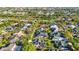 An aerial view of a residential community with mature trees and well-maintained lawns on a sunny day at 1068 Harbour Cape Pl, Punta Gorda, FL 33983