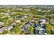 An aerial shot showcases a residential neighborhood with lush greenery, pools, and well-kept homes at 1068 Harbour Cape Pl, Punta Gorda, FL 33983