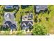 Aerial view of house with screened-in pool, gray roof, and solar panels amid manicured lawns at 1068 Harbour Cape Pl, Punta Gorda, FL 33983