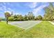 Outdoor basketball court with well-maintained surface and hoops, surrounded by lush greenery at 1068 Harbour Cape Pl, Punta Gorda, FL 33983