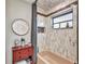 Charming bathroom with tiled shower, unique decor, and a red accent table, creating a stylish space at 1068 Harbour Cape Pl, Punta Gorda, FL 33983