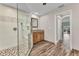 Bathroom features a granite vanity, a glass shower, and wood-look floors at 1068 Harbour Cape Pl, Punta Gorda, FL 33983