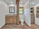 Well-lit bathroom with a wooden vanity, a toilet, and a cabinet for storage space at 1068 Harbour Cape Pl, Punta Gorda, FL 33983