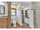 Bathroom with wooden vanity, toilet, and cabinet for storage at 1068 Harbour Cape Pl, Punta Gorda, FL 33983