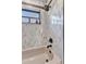 Bathroom featuring an updated shower with stylish fixtures, tiled walls, and a modern shower head at 1068 Harbour Cape Pl, Punta Gorda, FL 33983