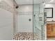 The updated bathroom features a seamless glass shower with decorative tiles and granite counters at 1068 Harbour Cape Pl, Punta Gorda, FL 33983