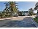 Neighborhood entrance with a palm tree, sign, and security gate at 1068 Harbour Cape Pl, Punta Gorda, FL 33983