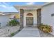 Inviting front entrance with decorative stone pillars and meticulously maintained landscaping at 1068 Harbour Cape Pl, Punta Gorda, FL 33983
