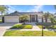 Lovely single-story home with three car garage, manicured lawn, and mature landscaping at 1068 Harbour Cape Pl, Punta Gorda, FL 33983