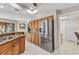 Kitchen with stainless steel refrigerator, granite countertops and wood cabinets at 1068 Harbour Cape Pl, Punta Gorda, FL 33983