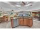 Kitchen with granite countertops, stainless appliances, peninsula with seating and open to the living room at 1068 Harbour Cape Pl, Punta Gorda, FL 33983