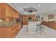 Kitchen with granite countertops, tile backsplash, stainless appliances, and bar stool seating at 1068 Harbour Cape Pl, Punta Gorda, FL 33983
