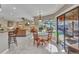 Bright kitchen open to a dining area with sliding glass doors to screened pool area at 1068 Harbour Cape Pl, Punta Gorda, FL 33983