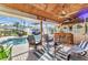 Spacious lanai with a tiki bar, comfortable seating, and a sparkling pool, creating a private retreat at 1068 Harbour Cape Pl, Punta Gorda, FL 33983