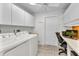 Functional laundry room with modern appliances, ample storage, and a convenient workspace, adding practicality at 1068 Harbour Cape Pl, Punta Gorda, FL 33983