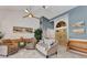 Cozy living room featuring tile floors, a soaring ceiling, and an abundance of natural light at 1068 Harbour Cape Pl, Punta Gorda, FL 33983