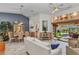 Open-concept living room with tile flooring and seamless access to the screened-in lanai and pool at 1068 Harbour Cape Pl, Punta Gorda, FL 33983