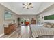 Comfortable main bedroom featuring wood-look flooring and a sliding door to the pool area at 1068 Harbour Cape Pl, Punta Gorda, FL 33983