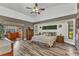Spacious main bedroom with wood floors and access to an outdoor bar and seating area at 1068 Harbour Cape Pl, Punta Gorda, FL 33983