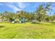 A fun community playground featuring climbing structures, slides, swings, and lush green space at 1068 Harbour Cape Pl, Punta Gorda, FL 33983