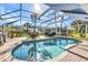 Beautiful screened-in pool with brick patio, summer kitchen and an outdoor dining area, perfect for entertaining at 1068 Harbour Cape Pl, Punta Gorda, FL 33983
