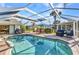 Enjoy this backyard's screened in pool, covered patio, dining and seating area, and lovely landscaping at 1068 Harbour Cape Pl, Punta Gorda, FL 33983