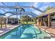 Gorgeous in-ground pool with seating and lounge area and summer kitchen, perfect for relaxing and entertaining at 1068 Harbour Cape Pl, Punta Gorda, FL 33983