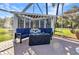 Outdoor seating area on brick patio with lounge furniture and tropical landscaping, perfect for relaxing outside at 1068 Harbour Cape Pl, Punta Gorda, FL 33983