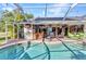 Outdoor kitchen with bar, island and patio seating, perfect for entertaining at 1068 Harbour Cape Pl, Punta Gorda, FL 33983