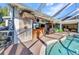 Outdoor kitchen with brick accents, island and bar seating, creating a perfect entertainment space at 1068 Harbour Cape Pl, Punta Gorda, FL 33983