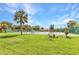 Great view of the community tennis courts with lush green landscaping and clear blue skies at 1068 Harbour Cape Pl, Punta Gorda, FL 33983