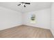 Bedroom featuring wood-look floors, a ceiling fan, and a window with a backyard view at 111 Swan Dr, Rotonda West, FL 33947