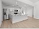 Open kitchen features stainless steel appliances, an island with seating, and wood-look flooring at 111 Swan Dr, Rotonda West, FL 33947