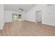 Large living room with wood-look floors and sliding doors to a patio at 111 Swan Dr, Rotonda West, FL 33947