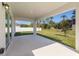 Covered patio offers an outdoor living space overlooking the lawn and lush landscaping at 111 Swan Dr, Rotonda West, FL 33947